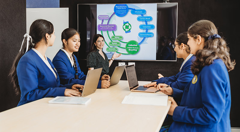 Dedicated teacher helping students in class at Nagle Catholic College South Blacktown