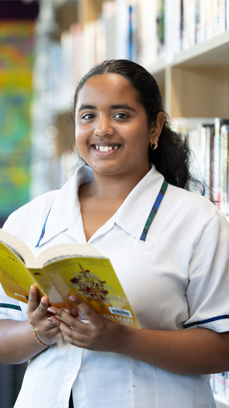 Nagle Catholic College student reading book in school library