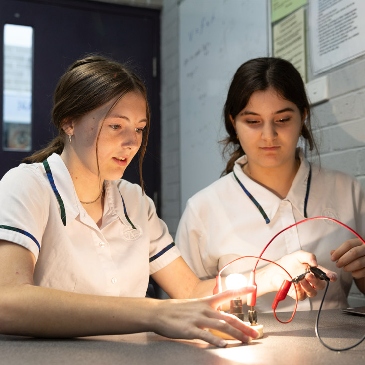 Two Nagle Catholic College students working on a science project